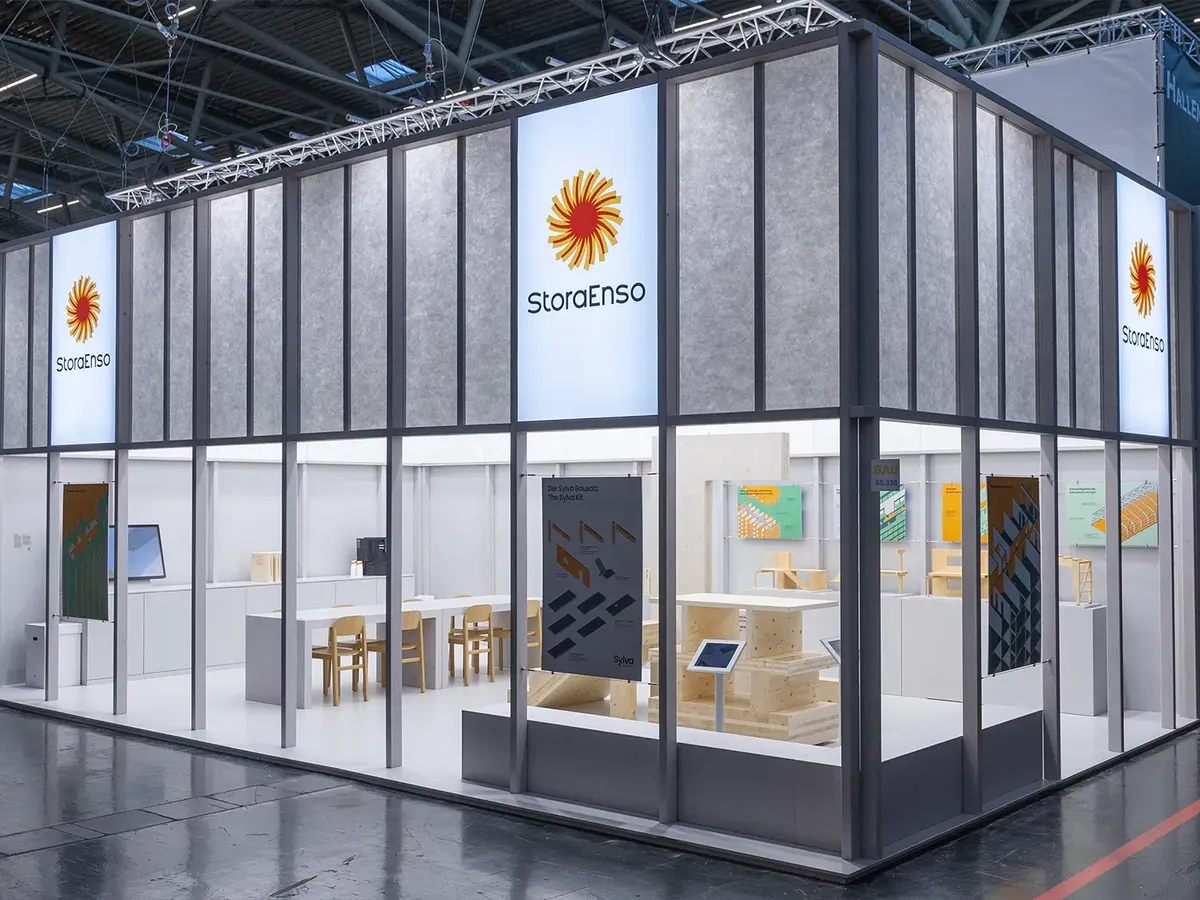 Minimalist Stora Enso stand at BAU 2025 with a clear spatial layout, technical product visualisations and consultation zones in wood and white